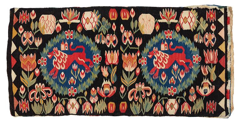 A cushion, 'Red Lion' (Rött Lejon), tapestry weave, c. 104 x 47 cm, Southwestern Scania, first part of the 19th century.