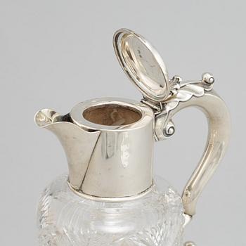 A glass and silver decanter, mark of W Devenport, Birmingham 1902.