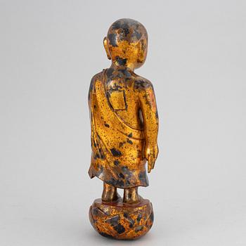 A Chinese wood gilt and lacquer sculpture of a boy, 20th Century.