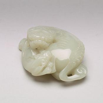 A Chinese nephrite figure of a reclining buddhist lion and its cub, presumably circa 1900.