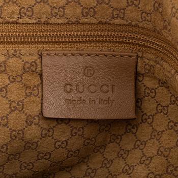 Gucci, a leather handbag.