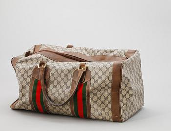 A beige monogram canvas with details in letaher by Gucci.