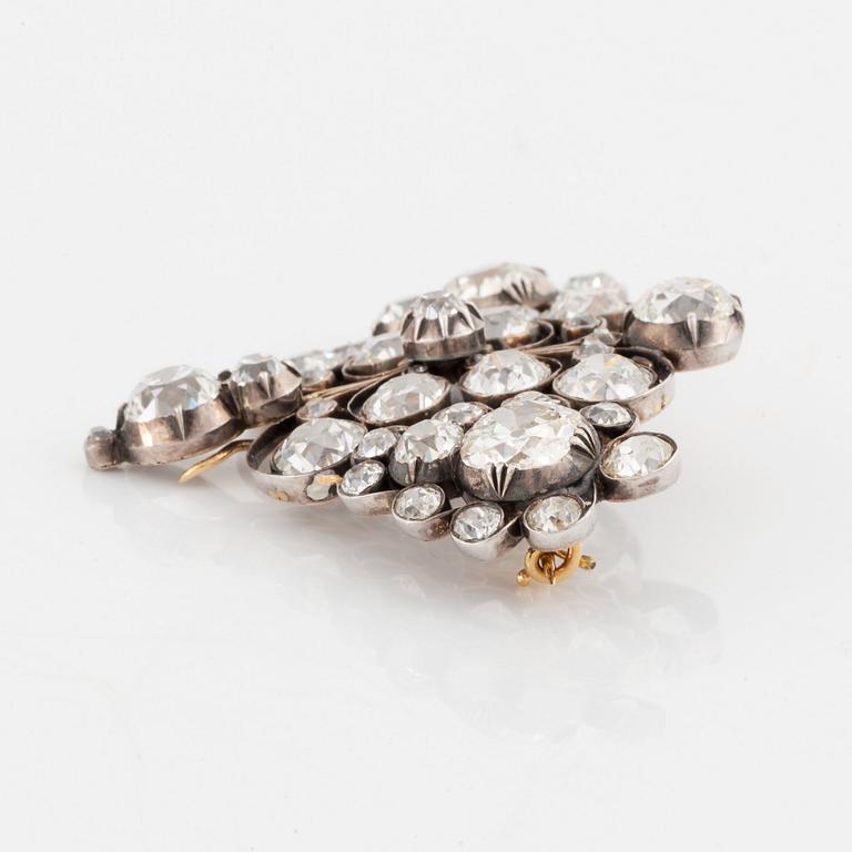 A gold and silver brooch set with old-cut diamonds.