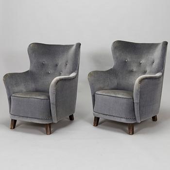 A pair of mid-20th century armchairs.