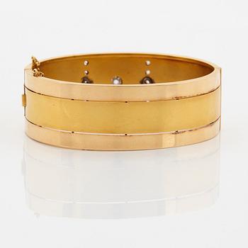 An 18K gold bracelet set with old-cut diamonds.