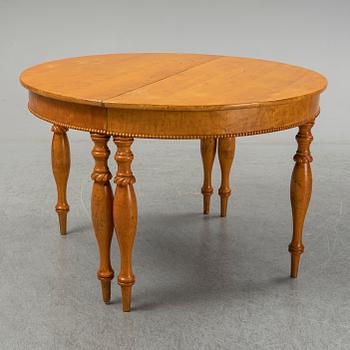 A mid 19th century birch dining table.