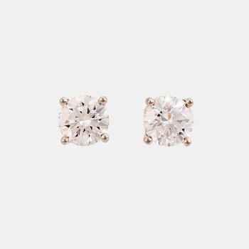 A pair of Tiffany solitaire diamond stud earrings in platinum.