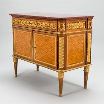 A French chest of drawer in Louis XVI style after Jean-Francois Leleu's school, late 19th century.