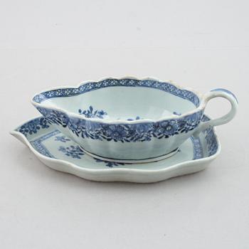 A blue and white vegetable tureen with cover and a sauce boat with a dish, Qing dynasty, 18th Century.