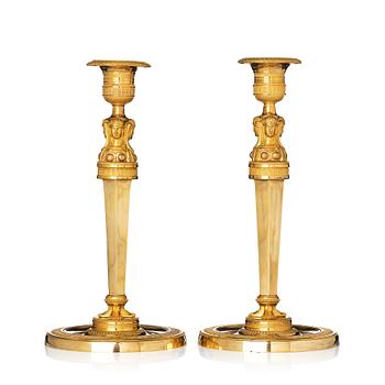 142. A pair of French Empire candlesticks, early 19th century.