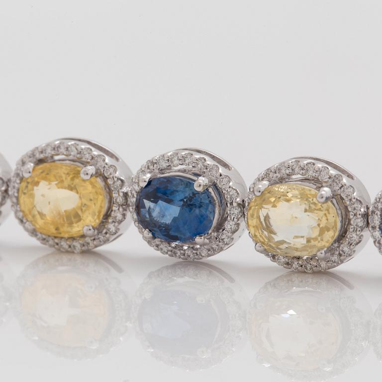 A yellow and blue sapphire and brilliant cut diamond bracelet. Total carat weight of sapphires circa 28.00 cts.