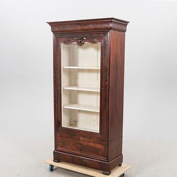 A walnut display cabinet around 1900.