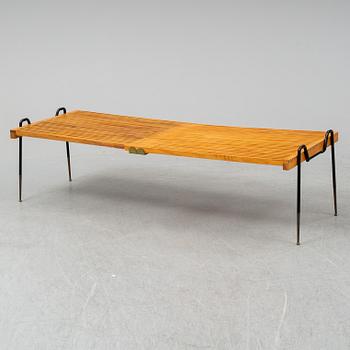 A mid 20th Century walnut extendible coffee table.