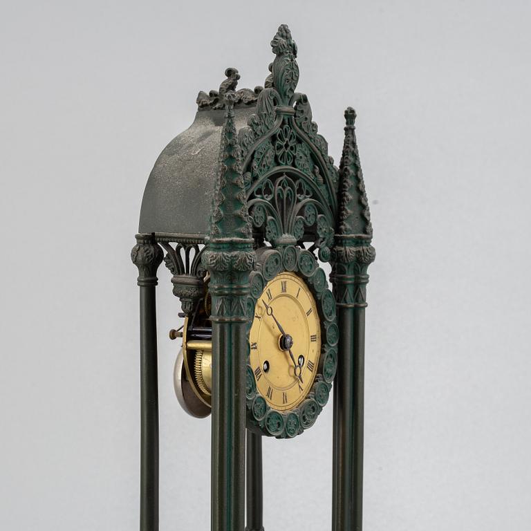 A cast iron gothic revival mantel clock, late 19th century.