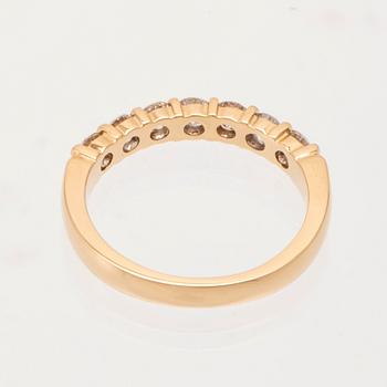 An 18K gold half-eternity ring set with round brilliant-cut diamonds.