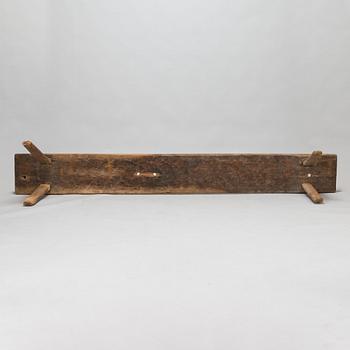 An 18th-century wooden bench dated 1782 with initials.