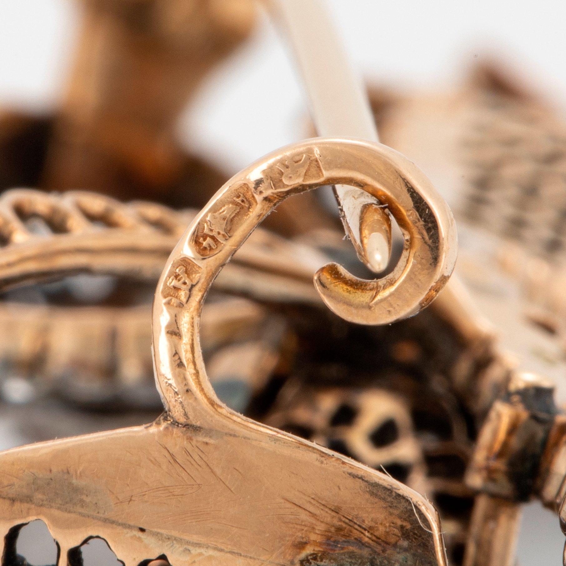 A 14K gold brooch set with old-cut diamonds.