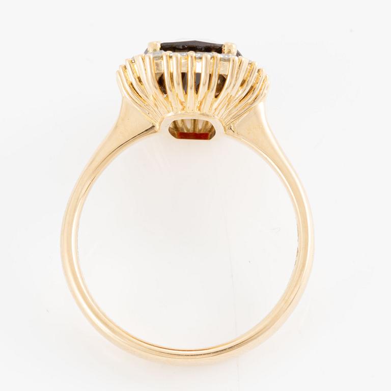 Ring with checkerboard-cut garnet and octagon-cut diamonds.