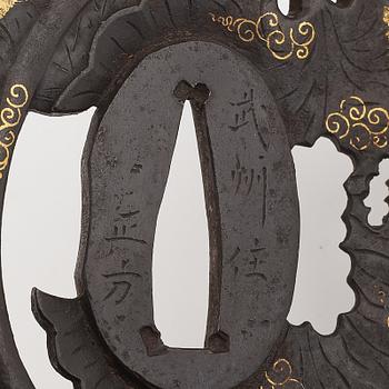 Three iron tsuba with gold inlay, two signed, Edo period.