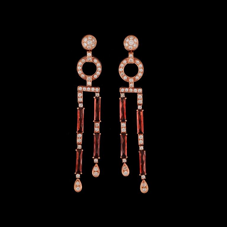 A pair of diamond, circa 2.40 ct, and garnet earrings.