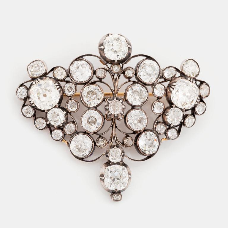 A gold and silver brooch set with old-cut diamonds.