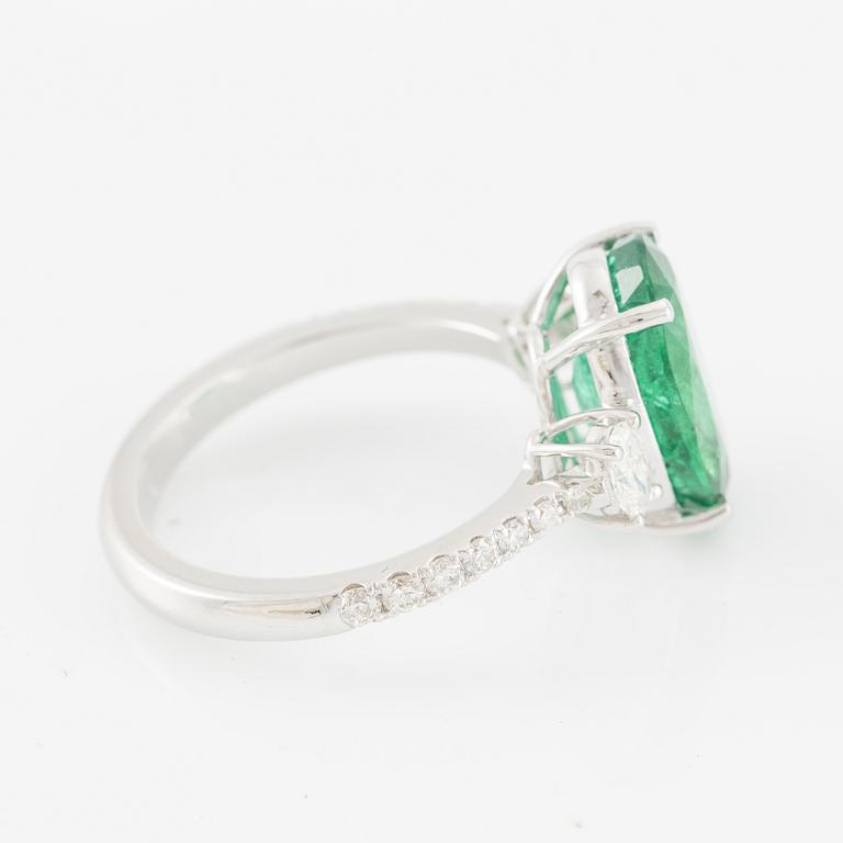 Ring in 18K white gold with an oval emerald and oval-cut and brilliant-cut diamonds.