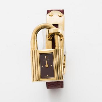 Hermès, a burgundy red leather bracelet with 14k gold plated watch, "Kelly Lock".