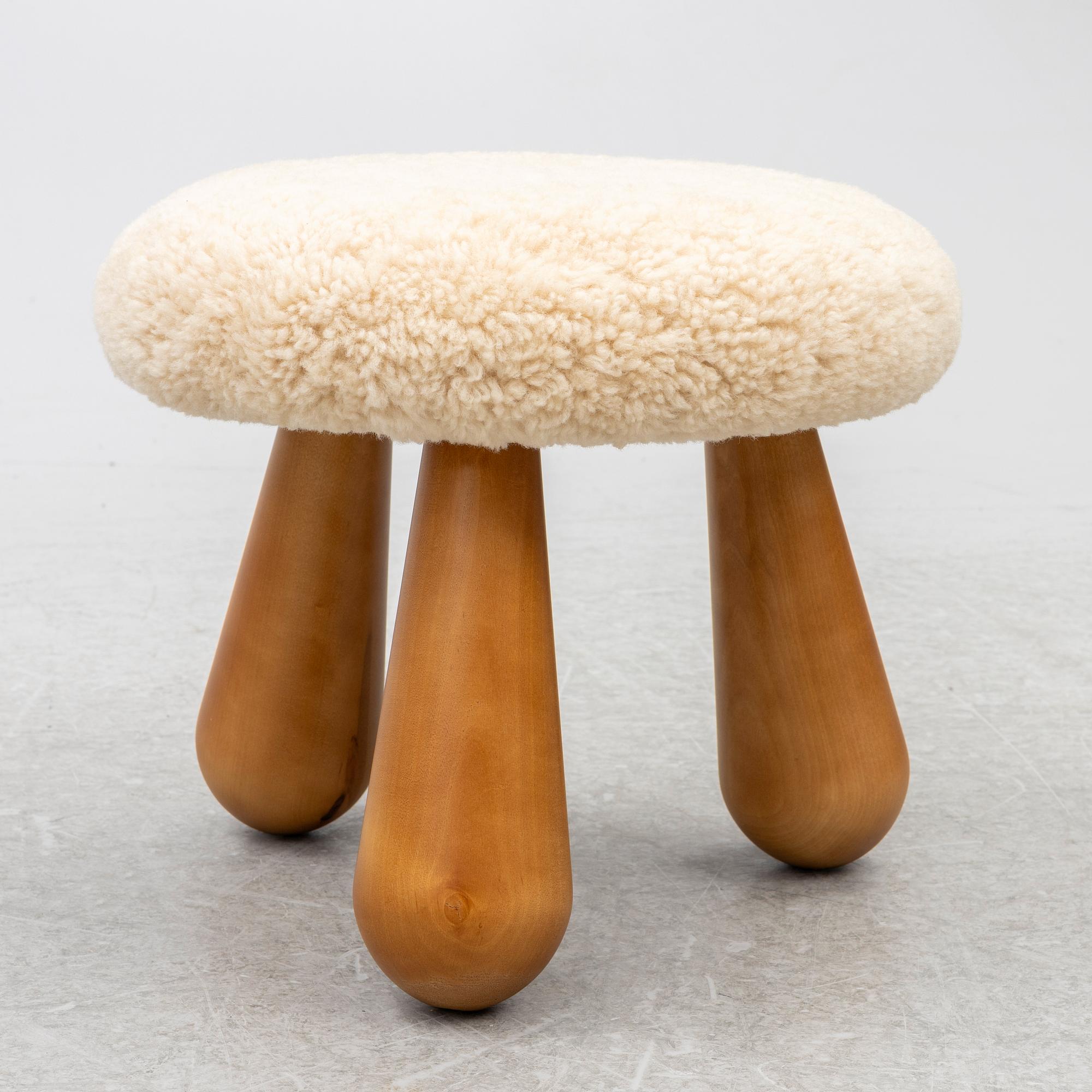 A contemporary stool with birch legs and new sheepskin upholstery.