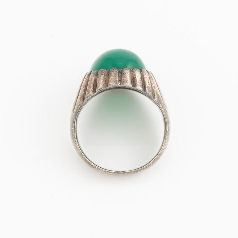 Silver ring with a green cabochon-cut stone.