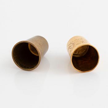 Two thimbles, 18K gold and brass.