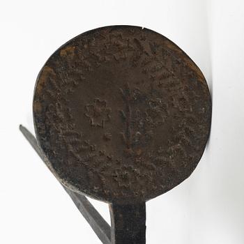 An iron wafer maker, dated 1662.