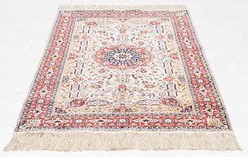 An oriental silk rug, c. 150 x 92 cm.