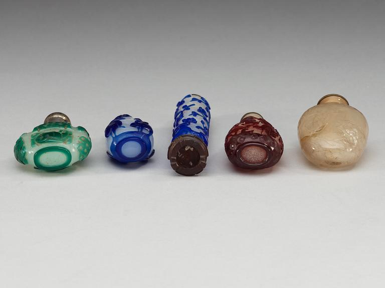 A set of five red, blue and green overlay glass snuff bottles, and one in rock crystal, late Qing dynasty (1644-1912).