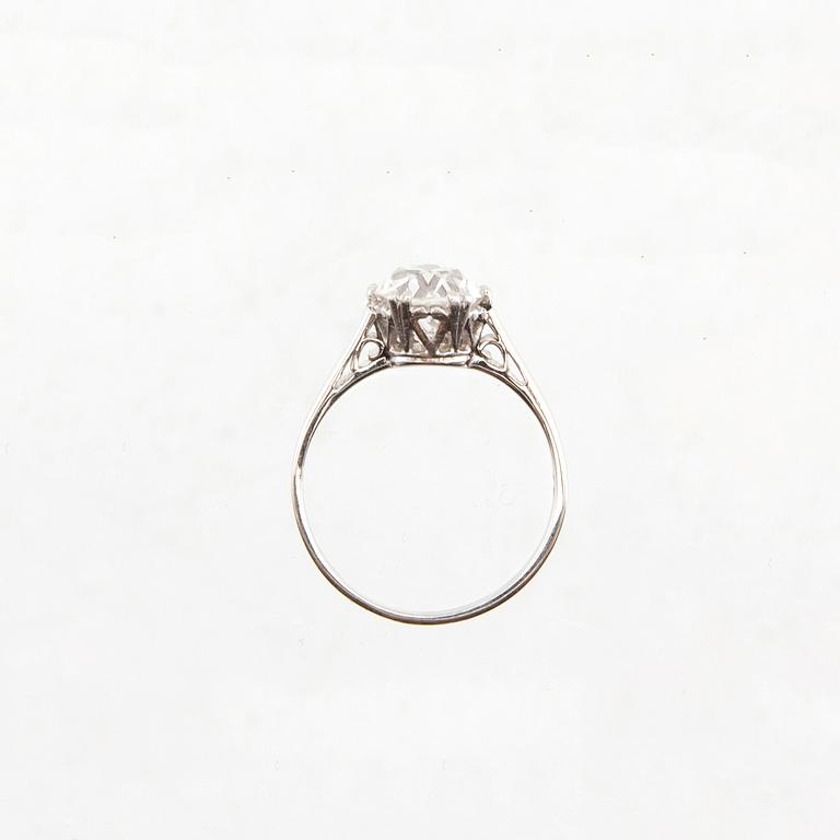 An 18K white gold solitaire ring set with a round old-cut diamond.