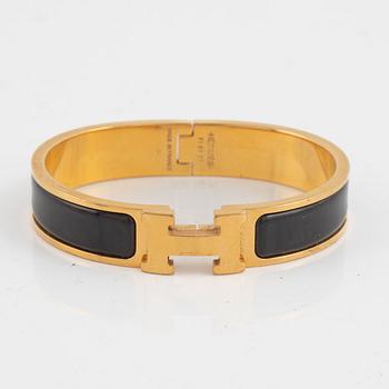 Hermès, a 'Clic H' bracelet.