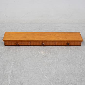 Nils Strinning, A 1950's-60's teak veneered shelf with brackets.