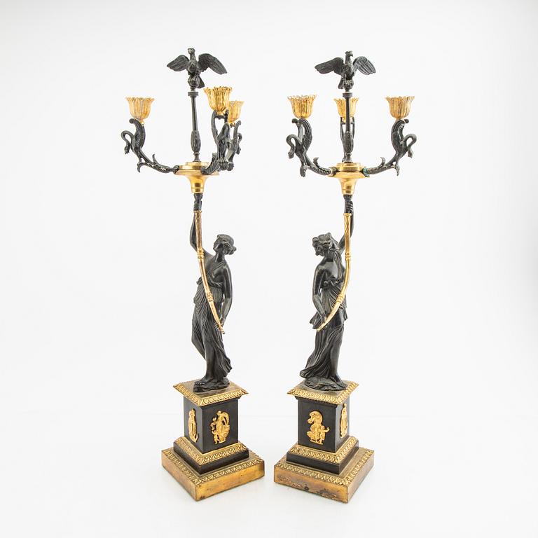 A pair (nearly) of Empire style candelabras later part of the 19th century.