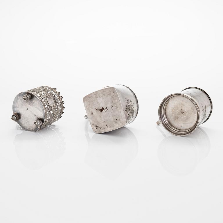 Three silver tea glass holders and four spoons, silver Kostroma and Moscow, late 19th and early 20th centuries.