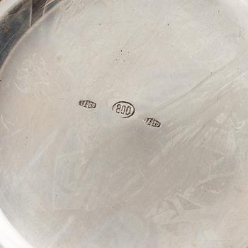 Three Silver Shakers and a Beaker.