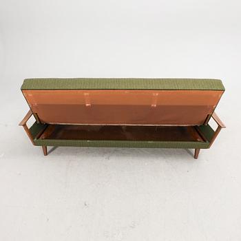 A 1960s teak sofa bed.