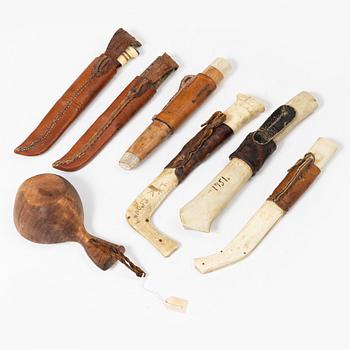 Six knives, and a cup.