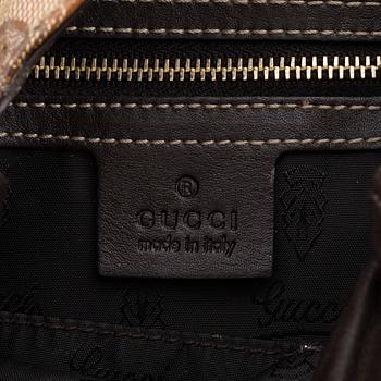 Gucci, a canvas handbag.