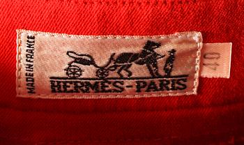 A pair of orange trousers by Hermès.