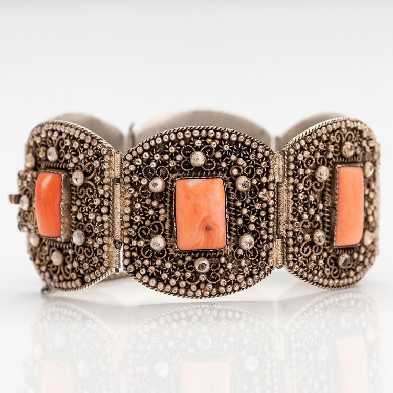 A silver bracelet with corals.