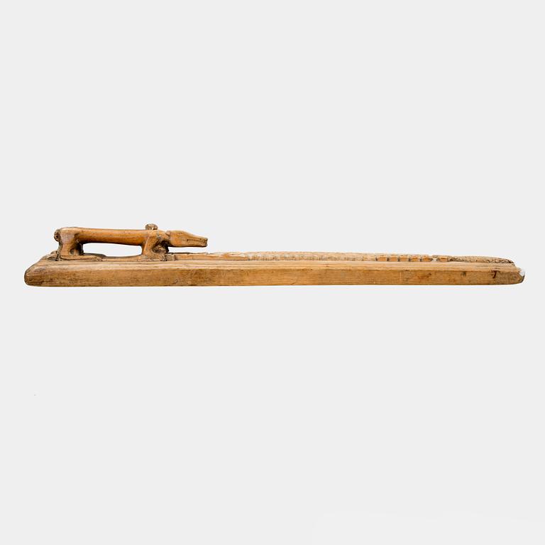 A Swedish folk art mangle board with carved decorationd, owners' initials and the date 1744.