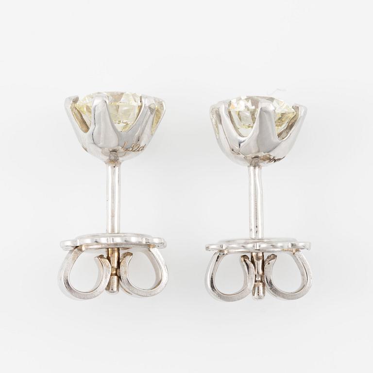 A pair of 14K gold earrings with round brilliant-cut diamonds.