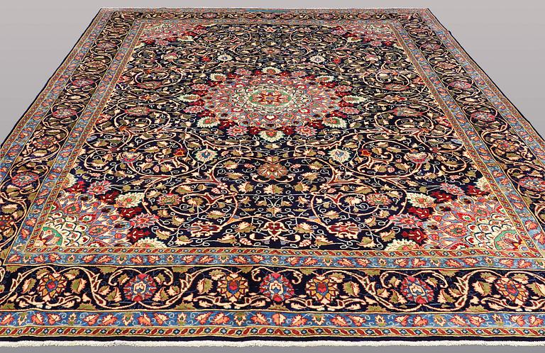A carpet, Kashmar, signed, ca 390 x 295 cm.