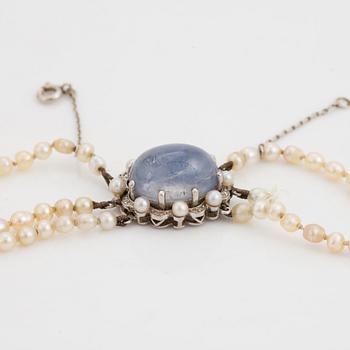 Three strand pearl necklace, clasp with cabochon cut sapphire.