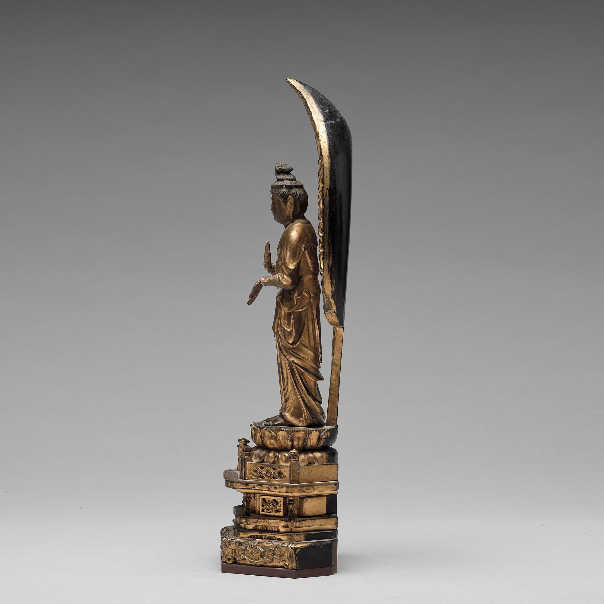 A Japanese gilt and lacquered wooden figure of Buddha and a travel shrine, Edo Period, 19th century.