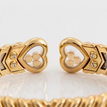 A Chopard "Happy Diamond" bangle in 18K gold.
